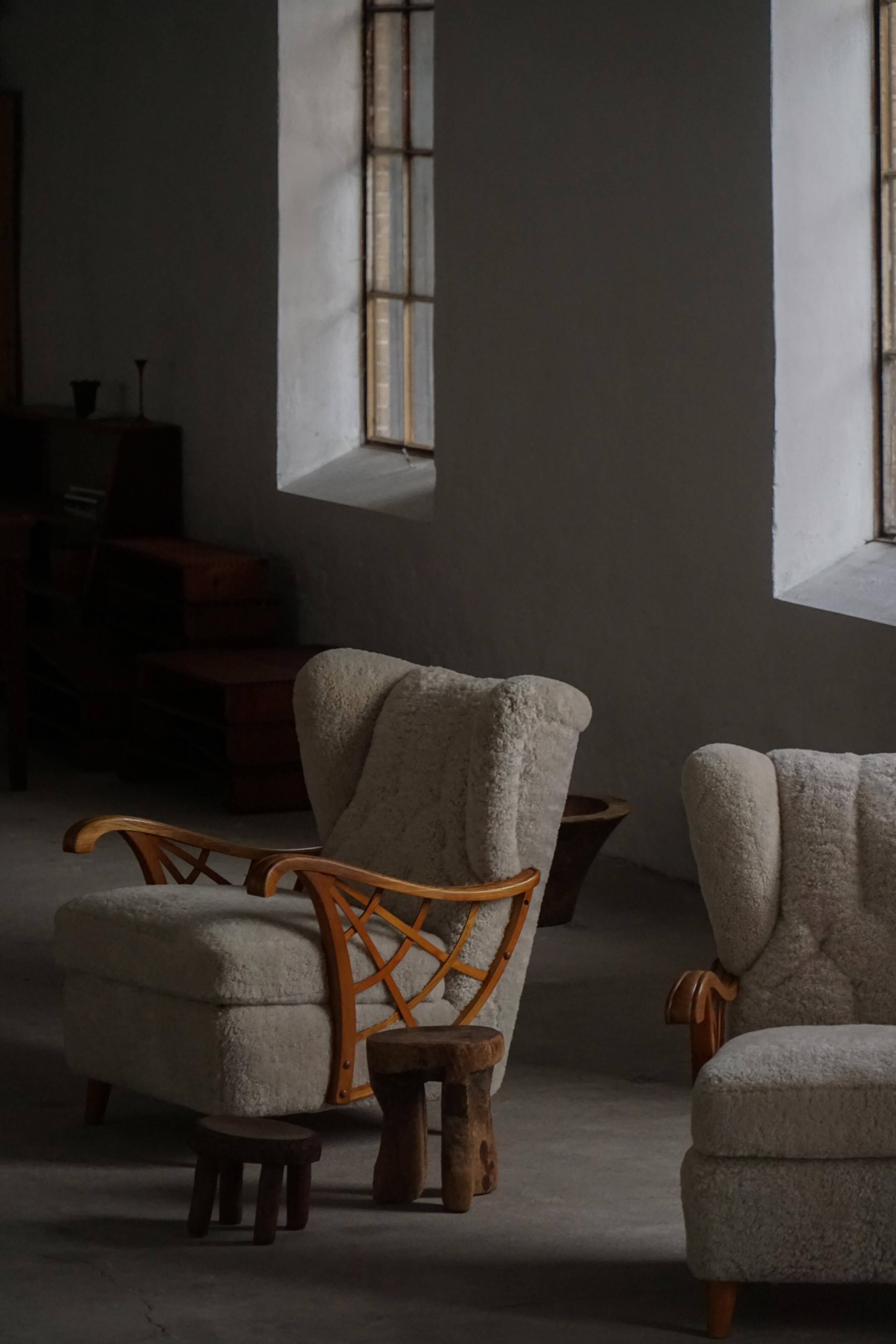 Pair of modern Swedish lounge chairs, shearling sheepskin and elm, 1940s.