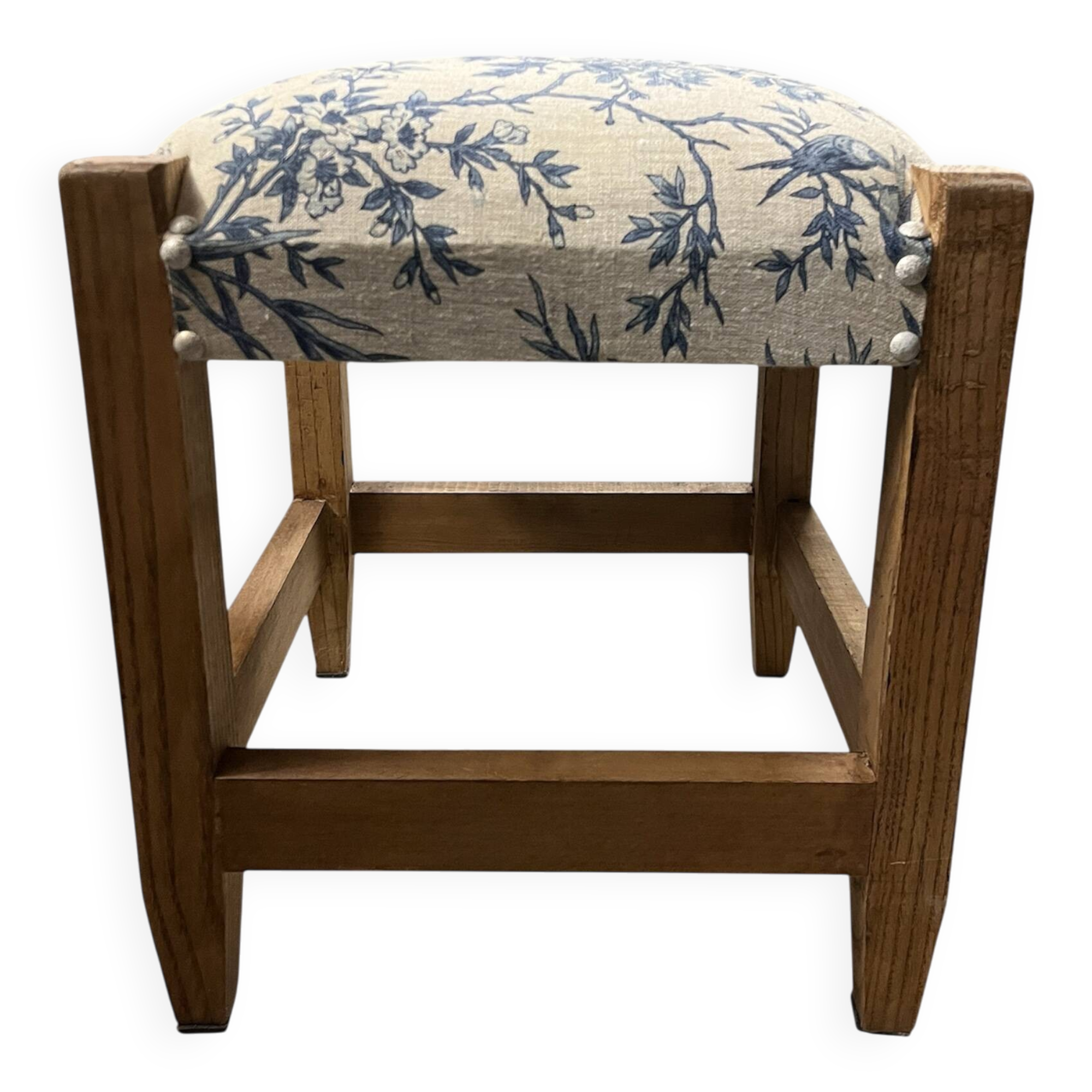 Square pouf with a checkered pattern.