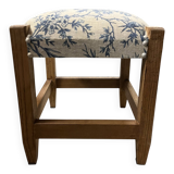 Square pouf with a checkered pattern.