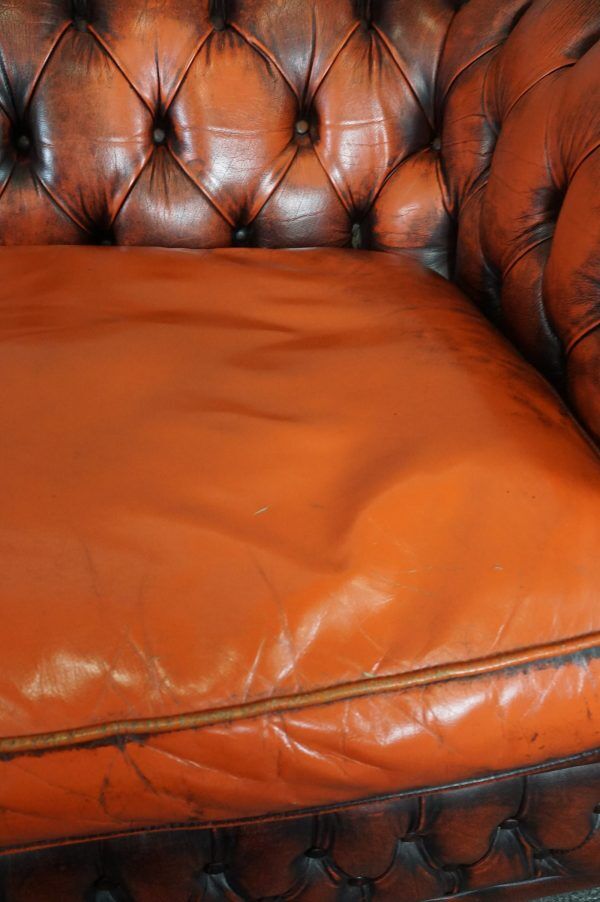 Chesterfield sofa in patinated orange leather, 2.5 seats