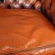 Chesterfield sofa in patinated orange leather, 2.5 seats