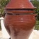 Large glazed terracotta jar, cognac colour with its lid.