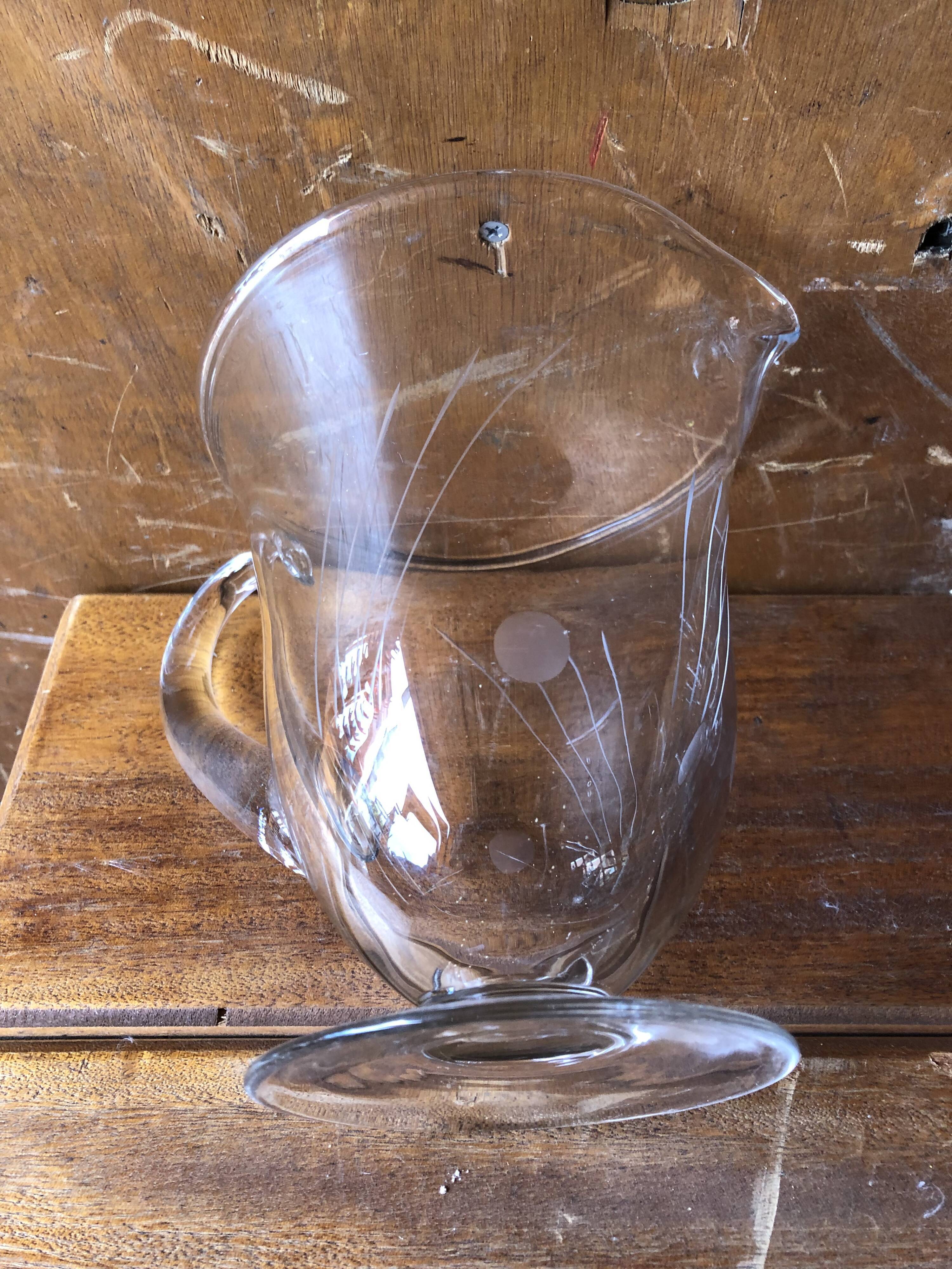 Old pitcher service and 5 foot glasses in engraved glass vintage table art
