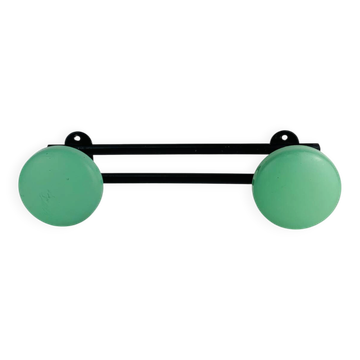 Wall-mounted coat rack with 2 green hooks from the 1950s.