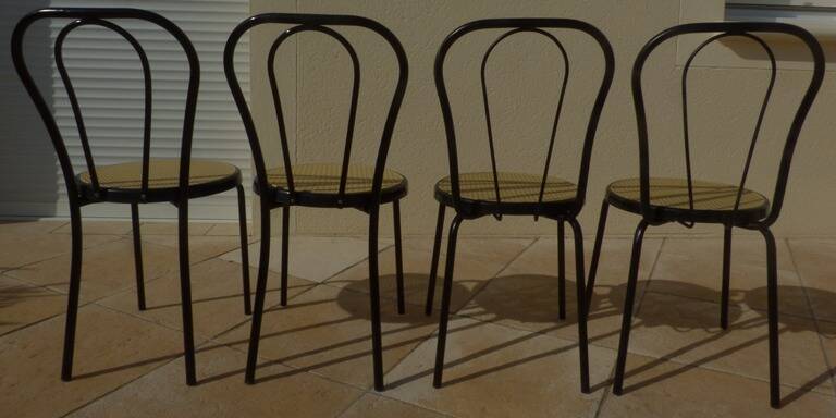 4 Black metal bistro chairs with plastic cane seat