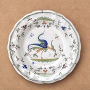 Hollow plate in Moustiers faience decorated with a bird, 19th century.