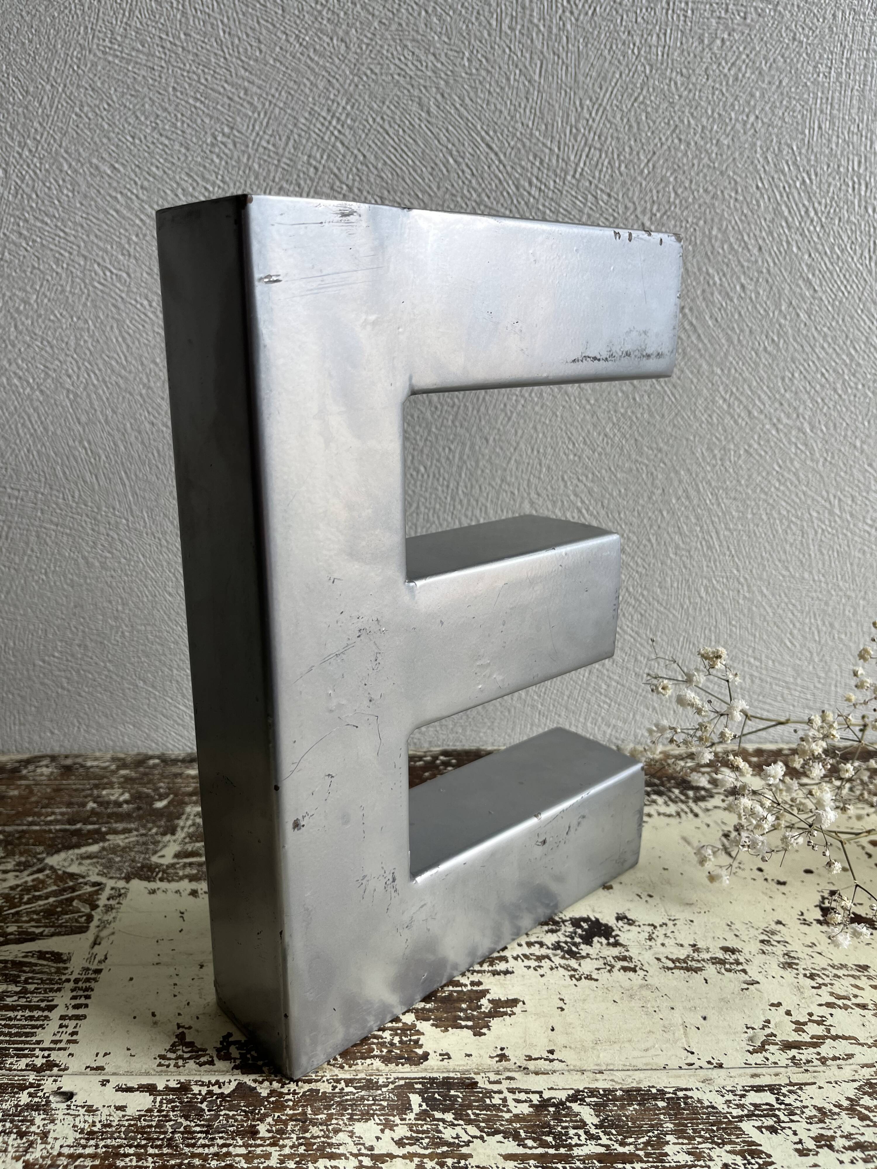 Metal sign letter E