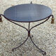 Table basse plateau verre noir et pompons bronze doré