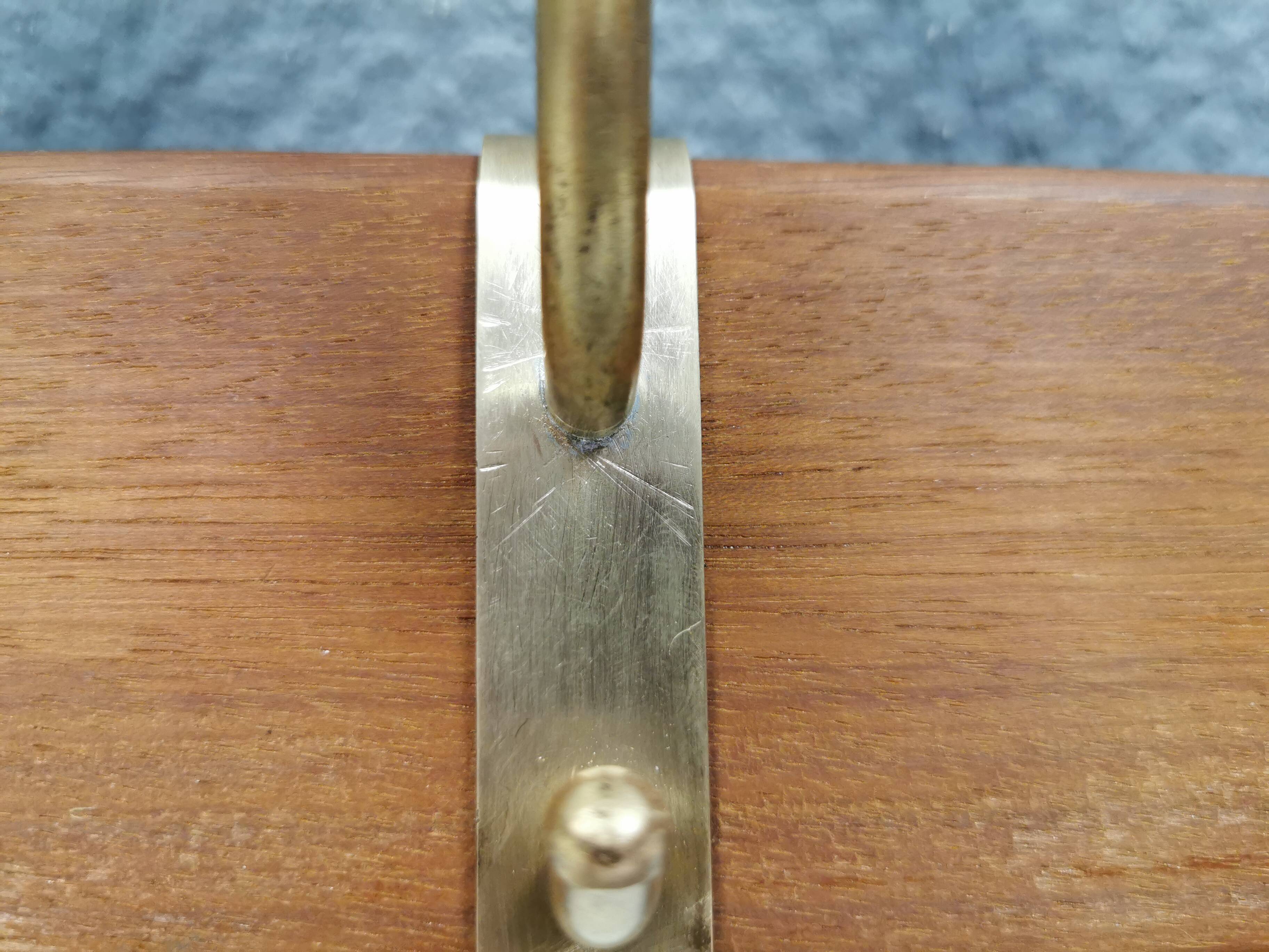 Danish teak and brass coat rack with adjustable hooks, 1960s.