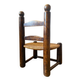 Low brutalist straw chair called fireplace chair