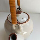 Flowered stoneware teapot with vintage rattan handle
