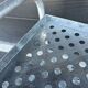 Four-wheeled dessert trolley with 4 perforated metal shelves.