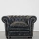 Spacious black cow leather chesterfield armchair with distinctive character