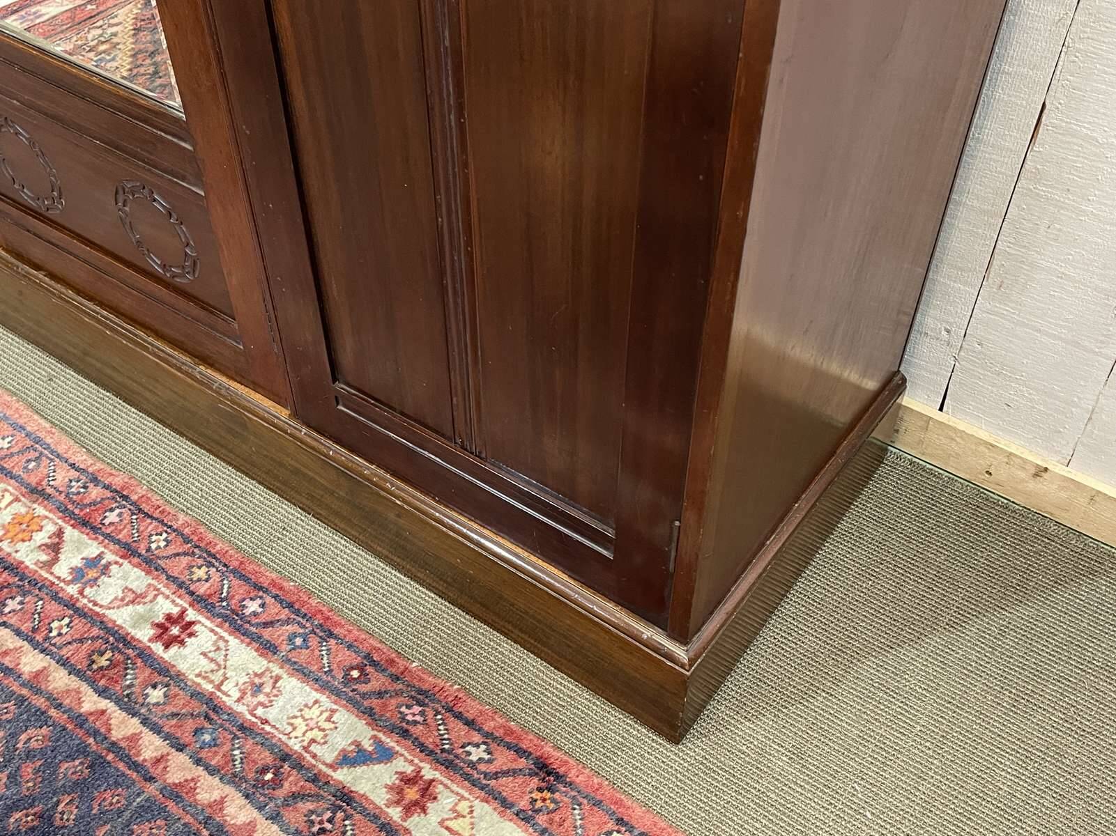 19th-century English mahogany three-door wardrobe.