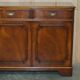 Vintage mahogany buffet with three drawers and shelves.