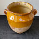 Old grease pot in glazed yellow terracotta, France nineteenth century
