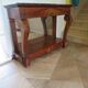 Empire/Restoration style console table with scrolled ends, mirrored back, and claw feet.