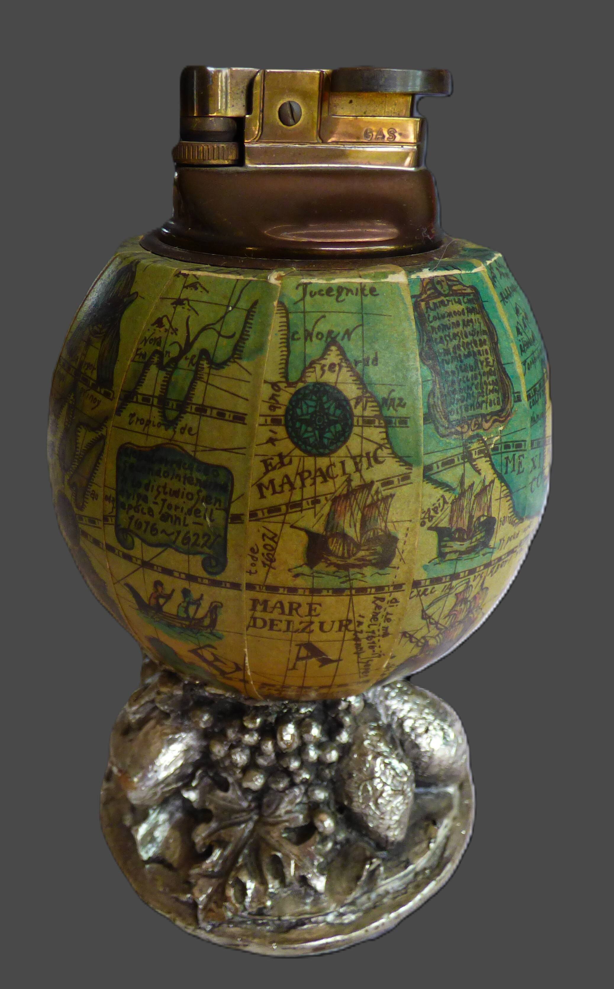 Vintage antique lighter with a globe and silver-plated stand.