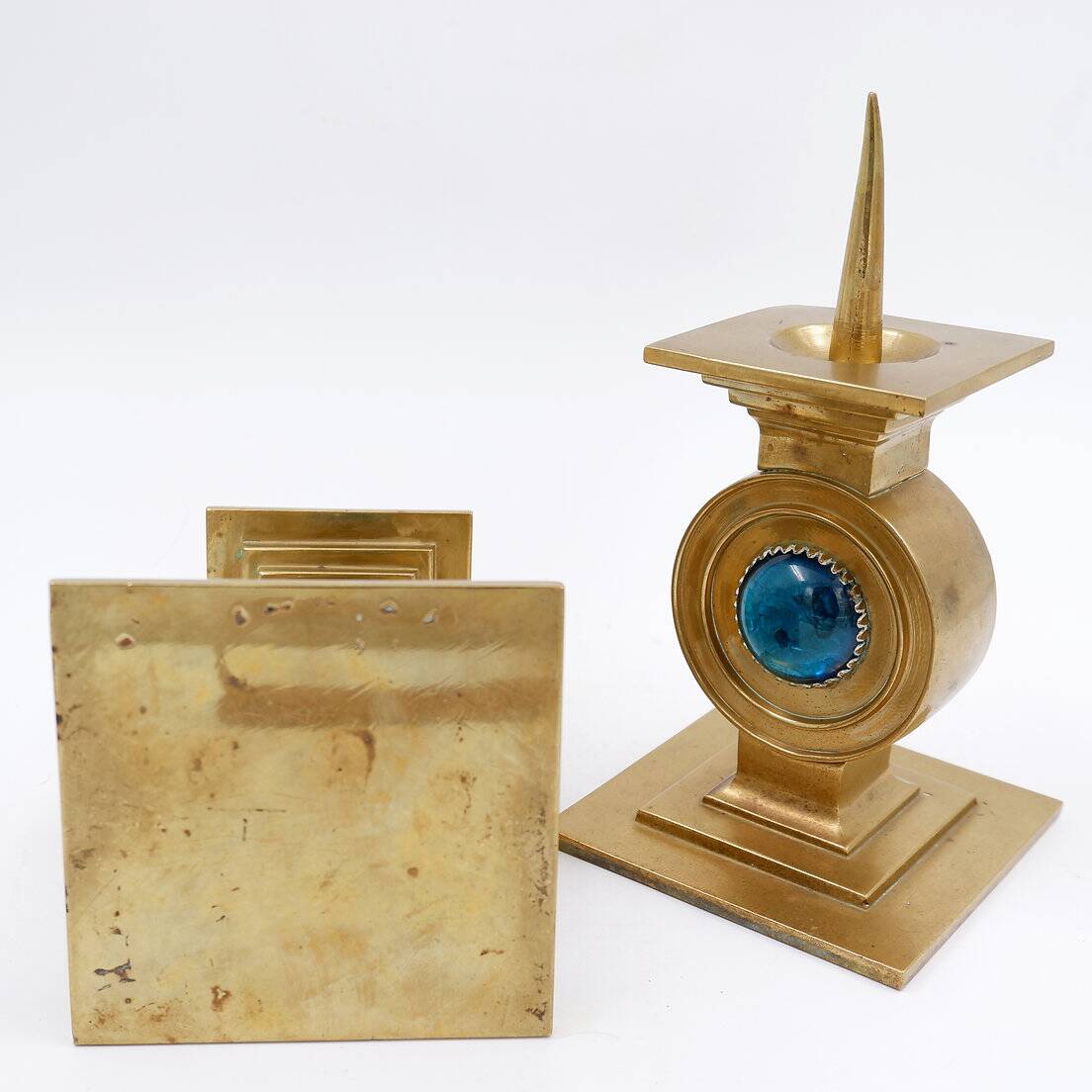 Pair of brass candlesticks decorated with a blue stone inlaid in the center