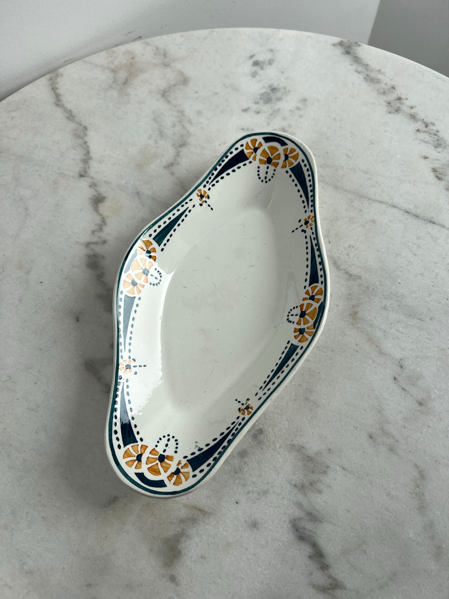 Longwy ramekin with blue and orange floral decoration.