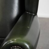 Smooth classic cowhide Chesterfield armchair in a stylish dark green color