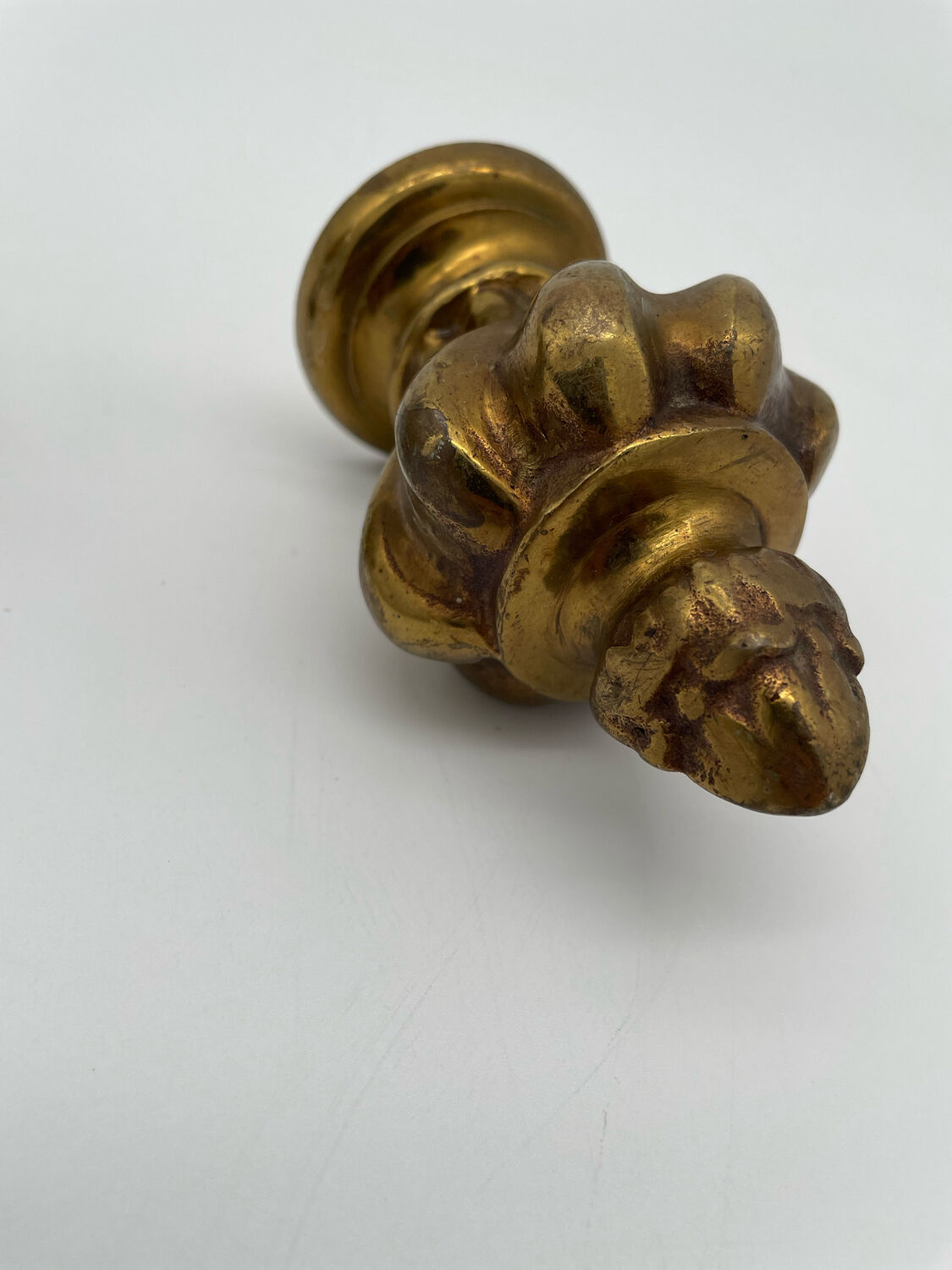 Pair of antique flame curtain rod finials in gilded bronze