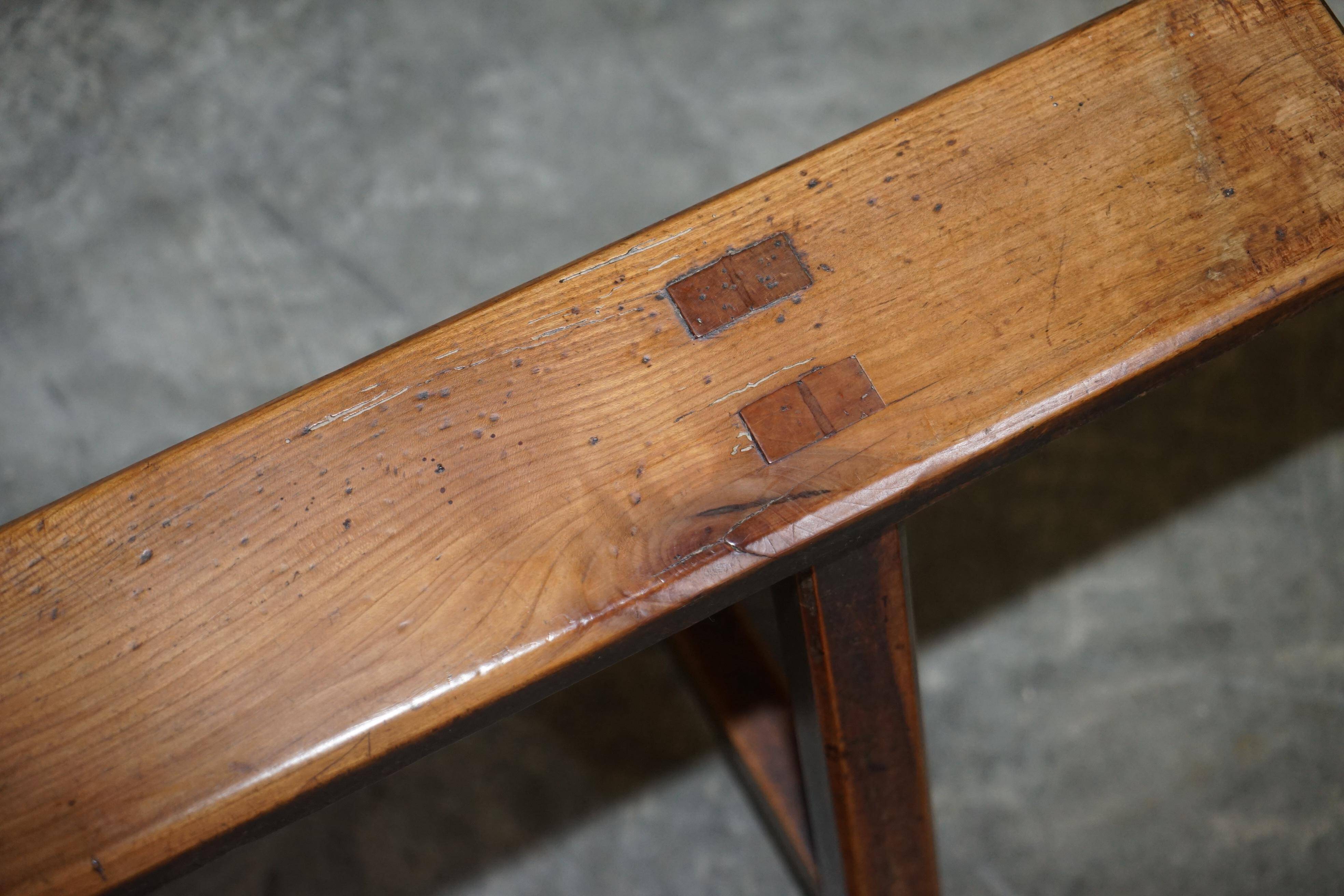 Pair of antique Victorian trestle benches in fruitwood.
