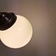 Small Art Deco hanging lamp in cream coloured glass and bakelite top.