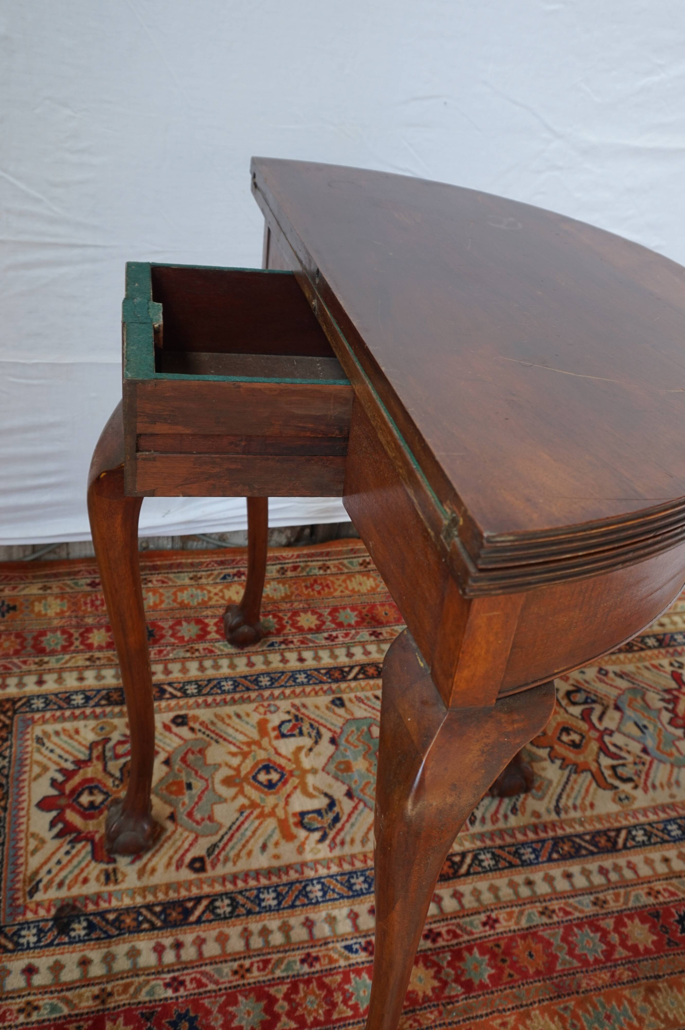 A half-moon english mahogany games table
