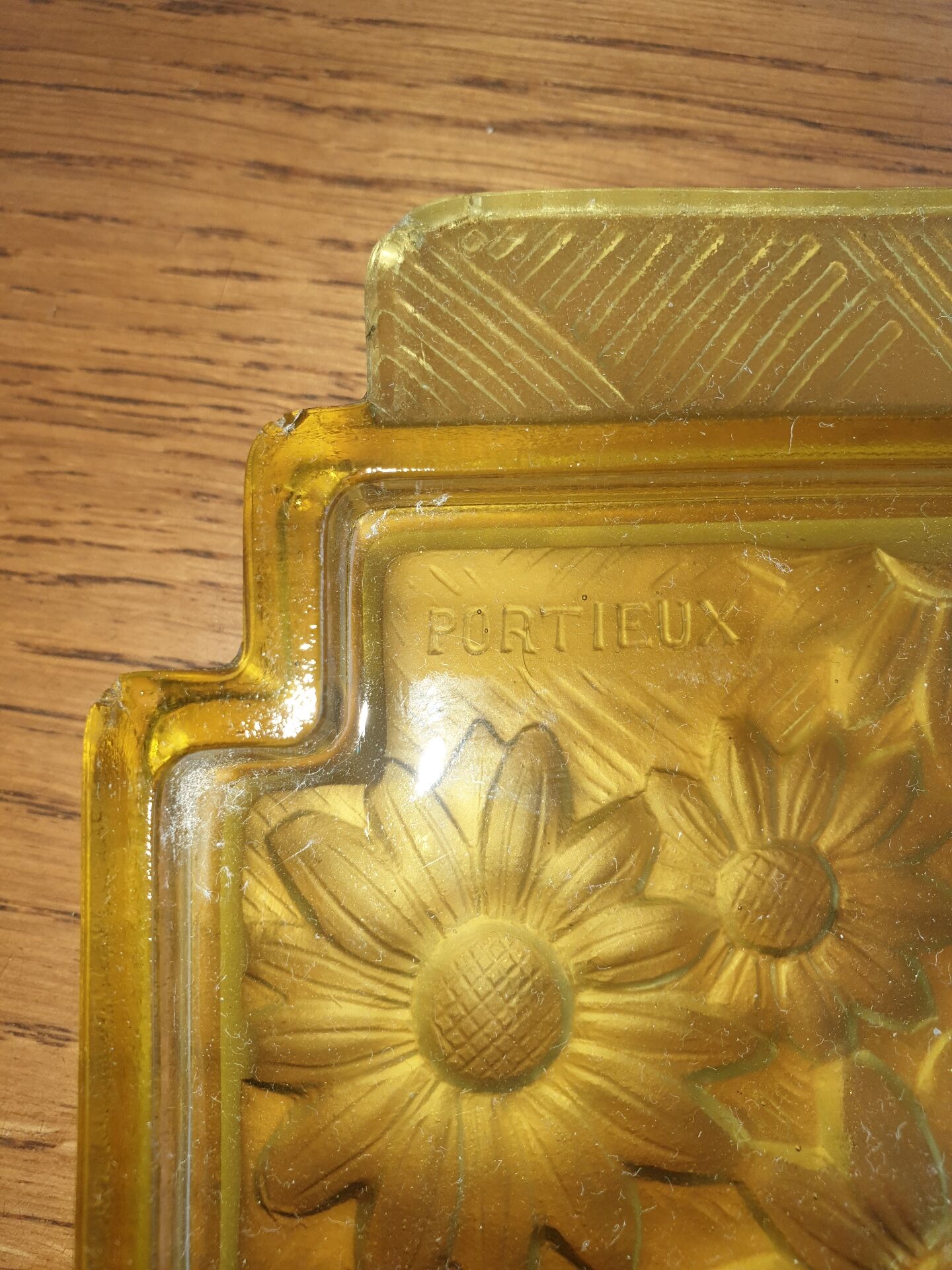 Pressed glass yellow bowl with floral pattern by Portieux.