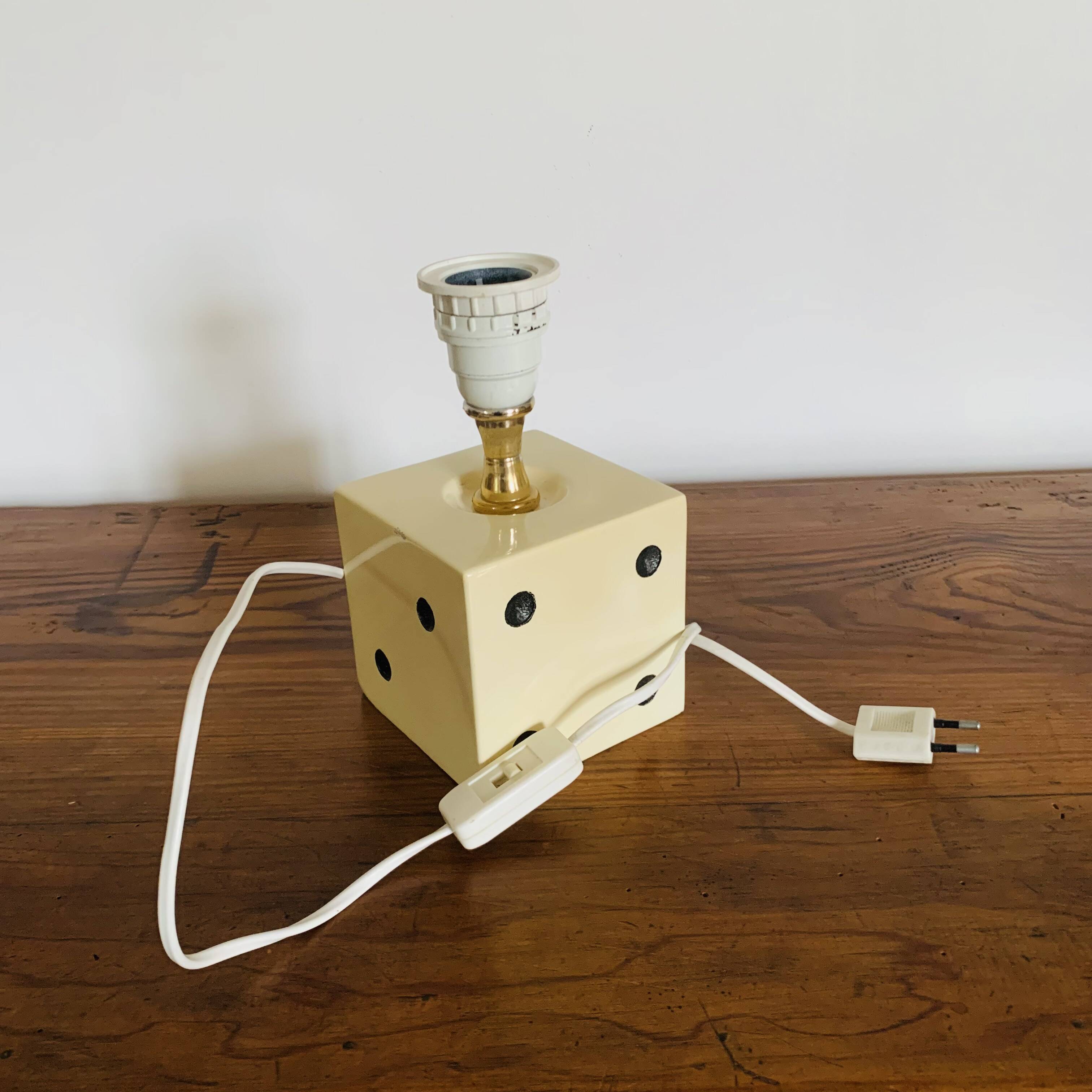 Lamp base representing a die