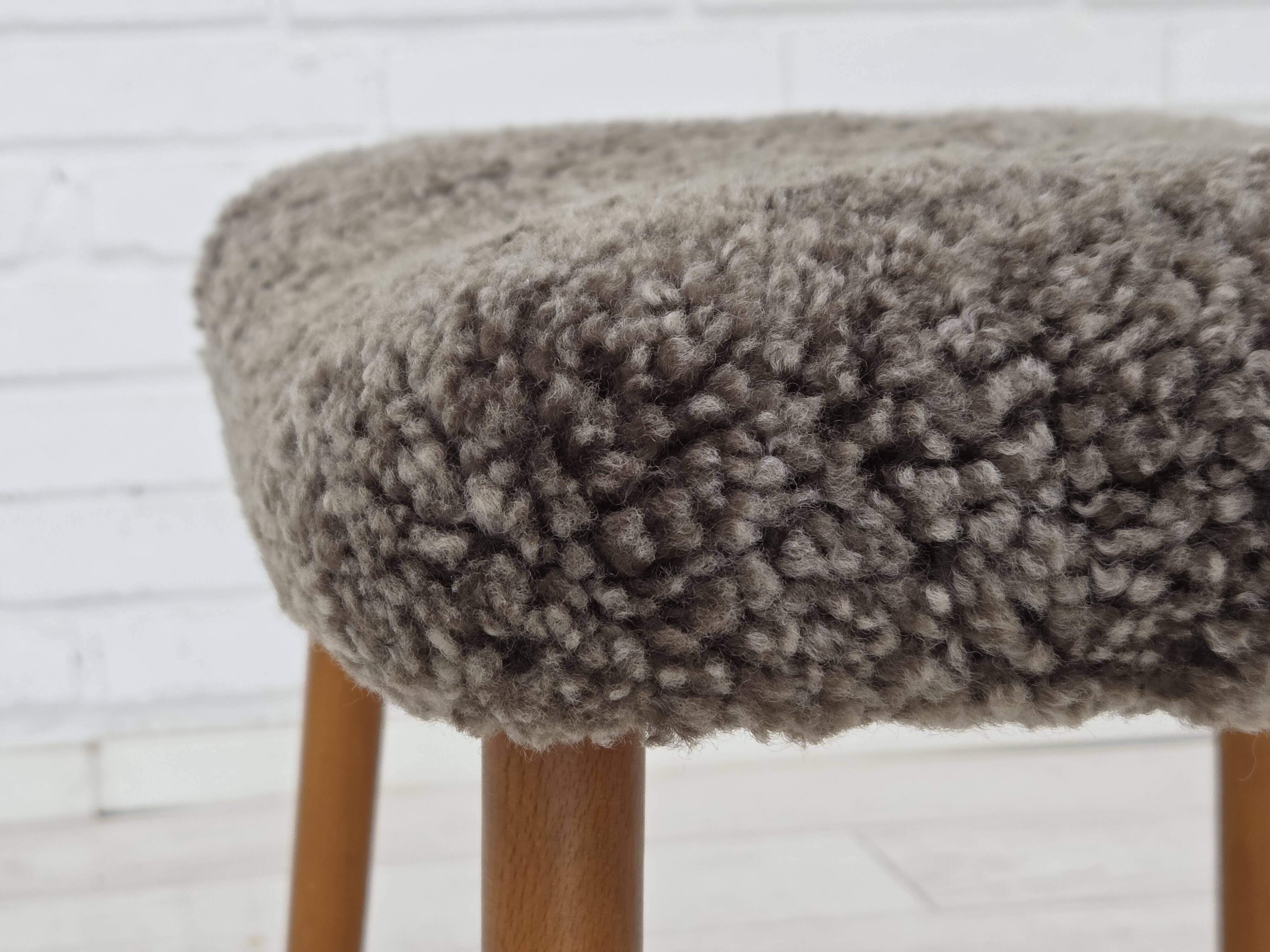 1960s, reupholstered Danish armchair, with stool, genuine sheepskin.