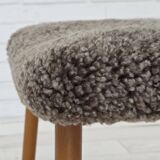 1960s, reupholstered Danish armchair, with stool, genuine sheepskin.