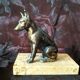 Greenhouse book dog sculpture regulates on marble slab