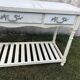 Console in painted wood, off-white patina, 3 drawers, lower shelf.