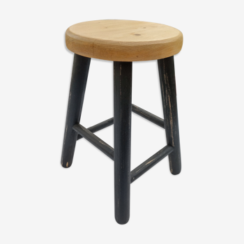 Low wooden stool and black patina
