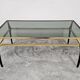 Mid Century Modern coffee table with gold-plated metal and smoked glass.