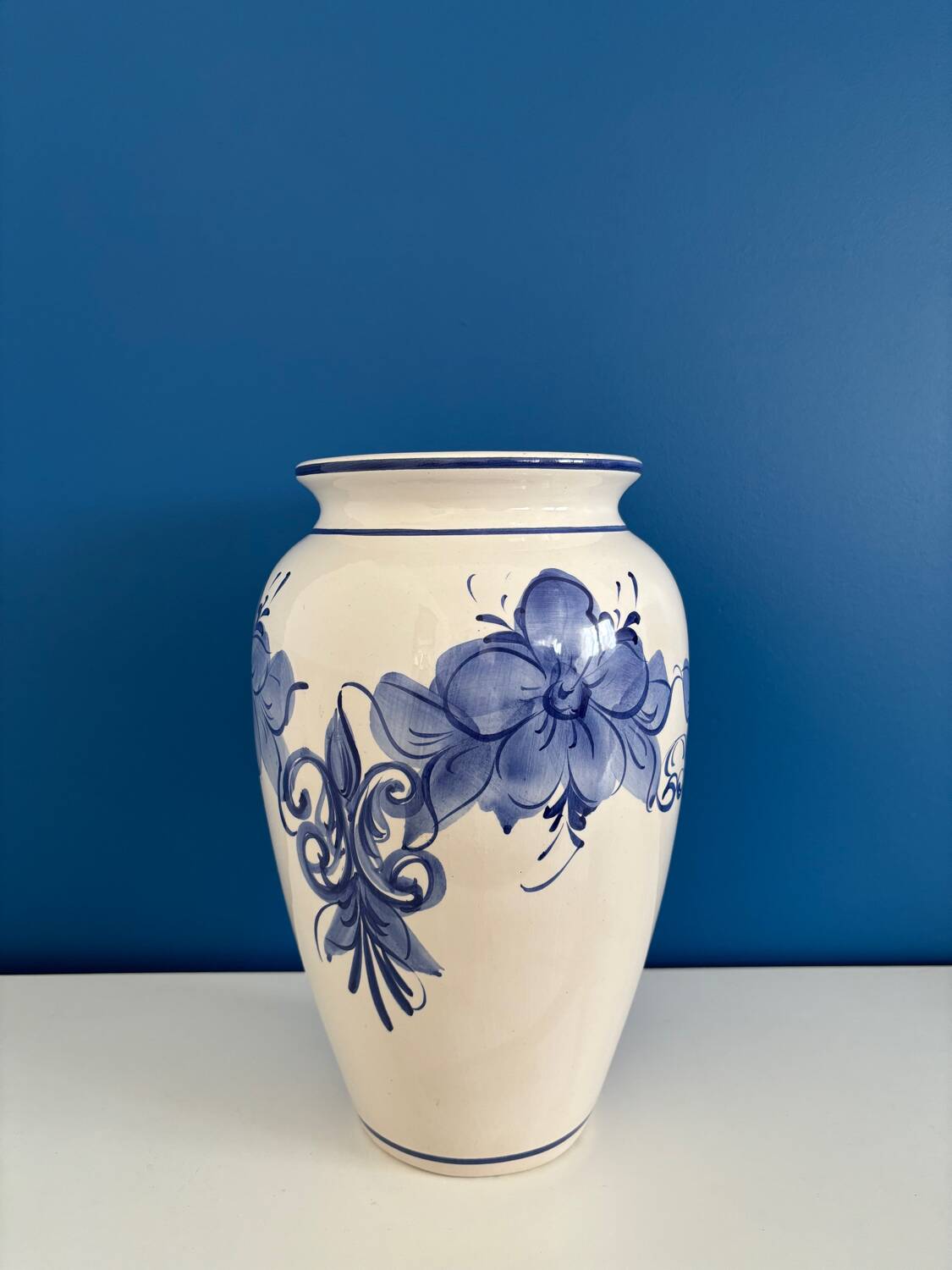 Vintage white and blue ceramic vase with floral pattern
