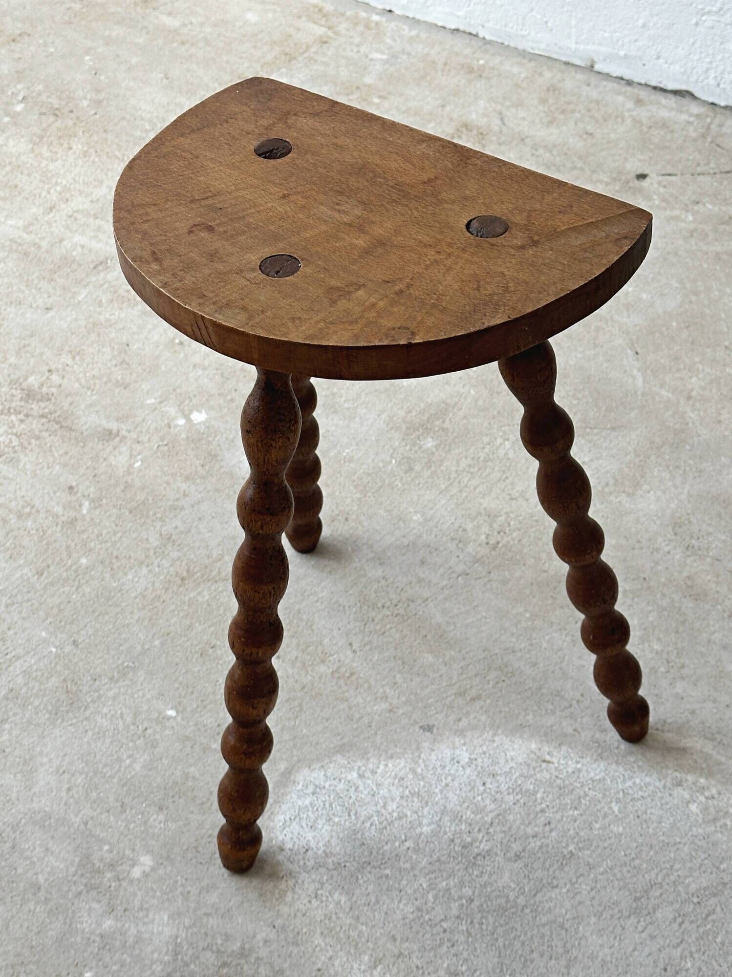 Antique solid wood stool with turned legs.