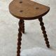 Antique solid wood stool with turned legs.