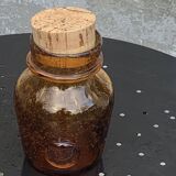 Blown and bubbled glass jar in the style of Biot glassworks, amber color