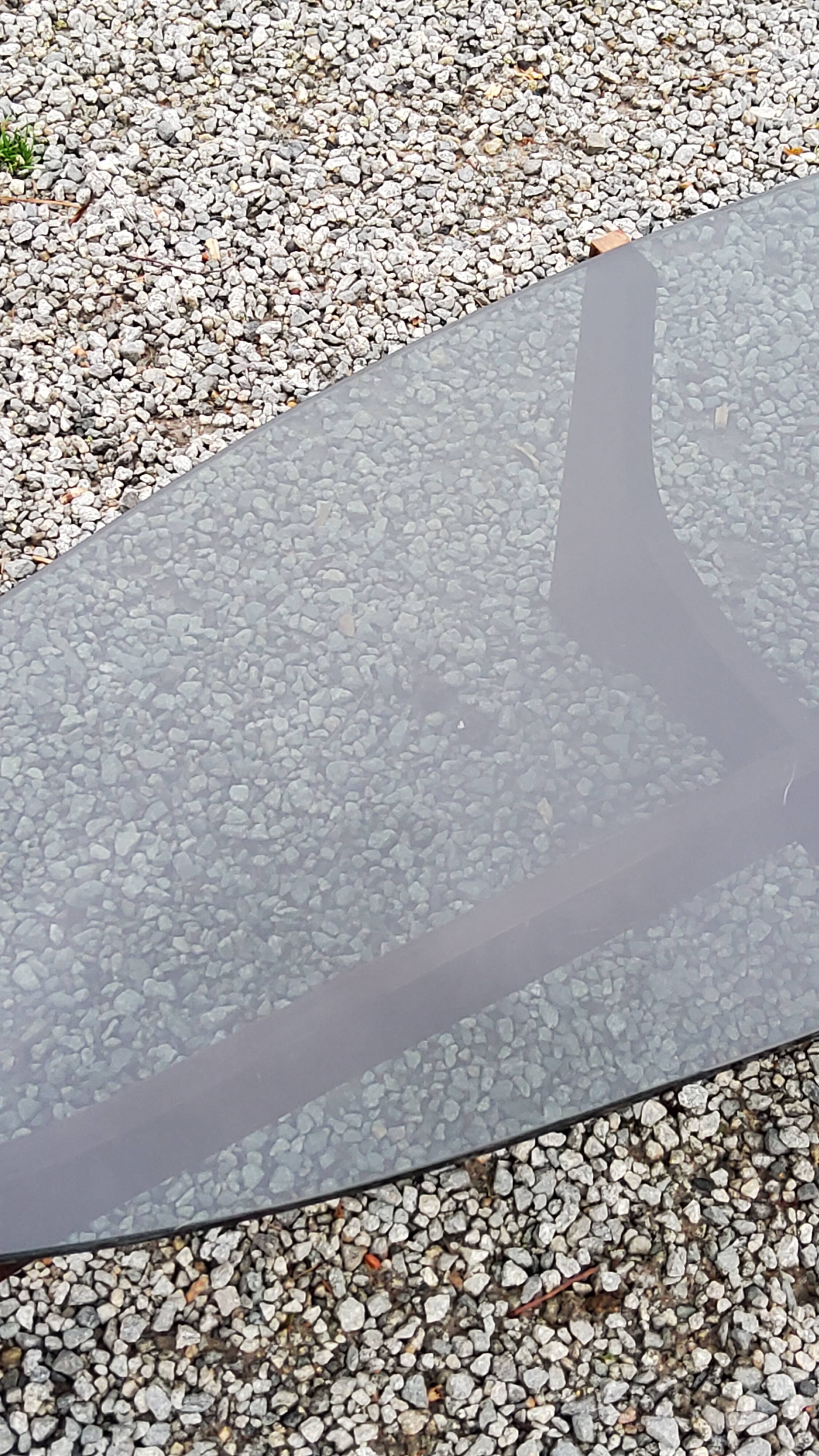 Designer coffee table by Hugues Poignant in rosewood and smoked glass from the 70s