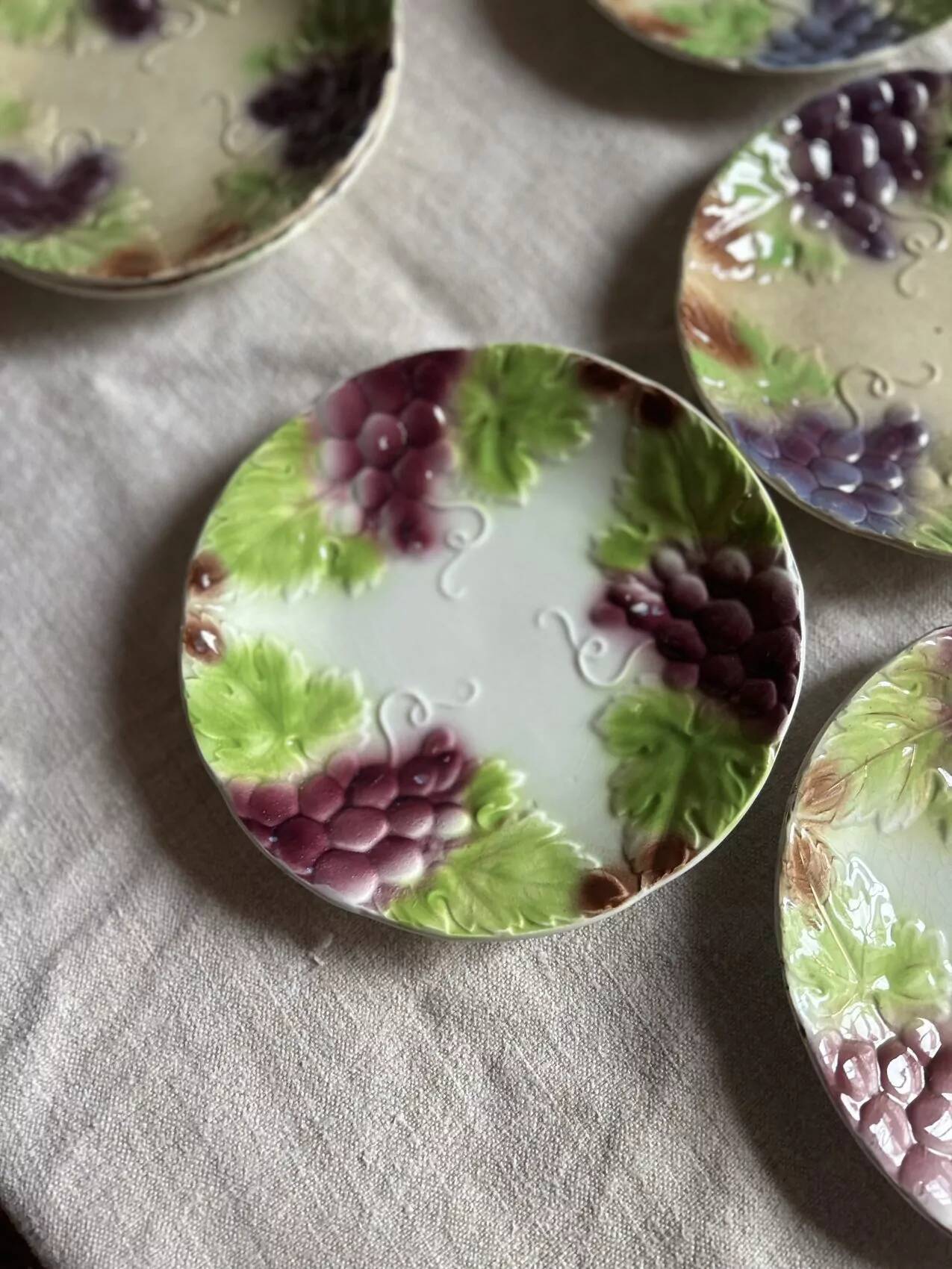 Set of eight flat dessert plates in barbotine earthenware with grape decoration – circa 1900.