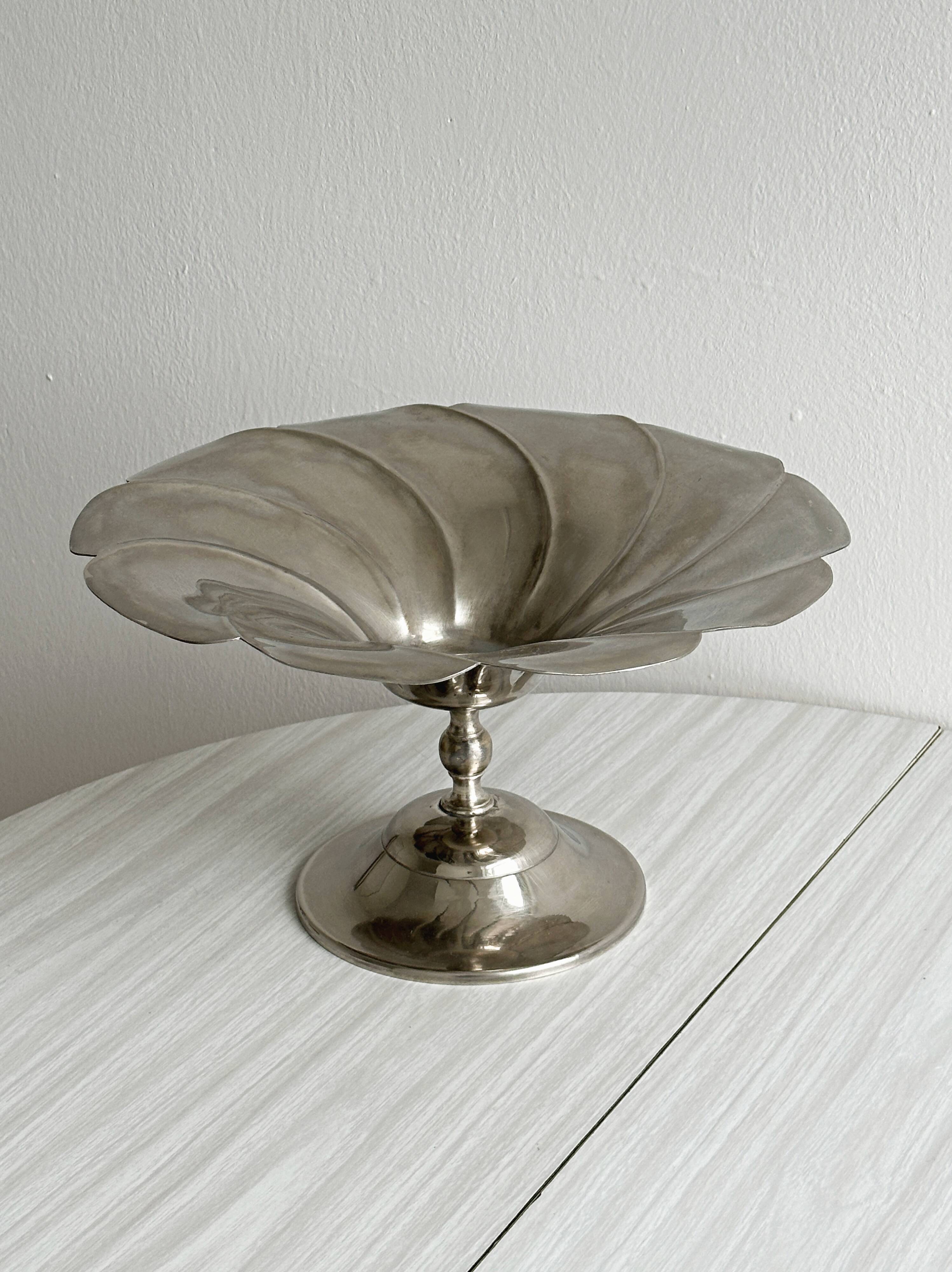 large dish on a shiny metal stand