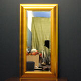 Large mirror in a golden decorative frame