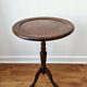 Small tripod wooden table with a vintage round top -