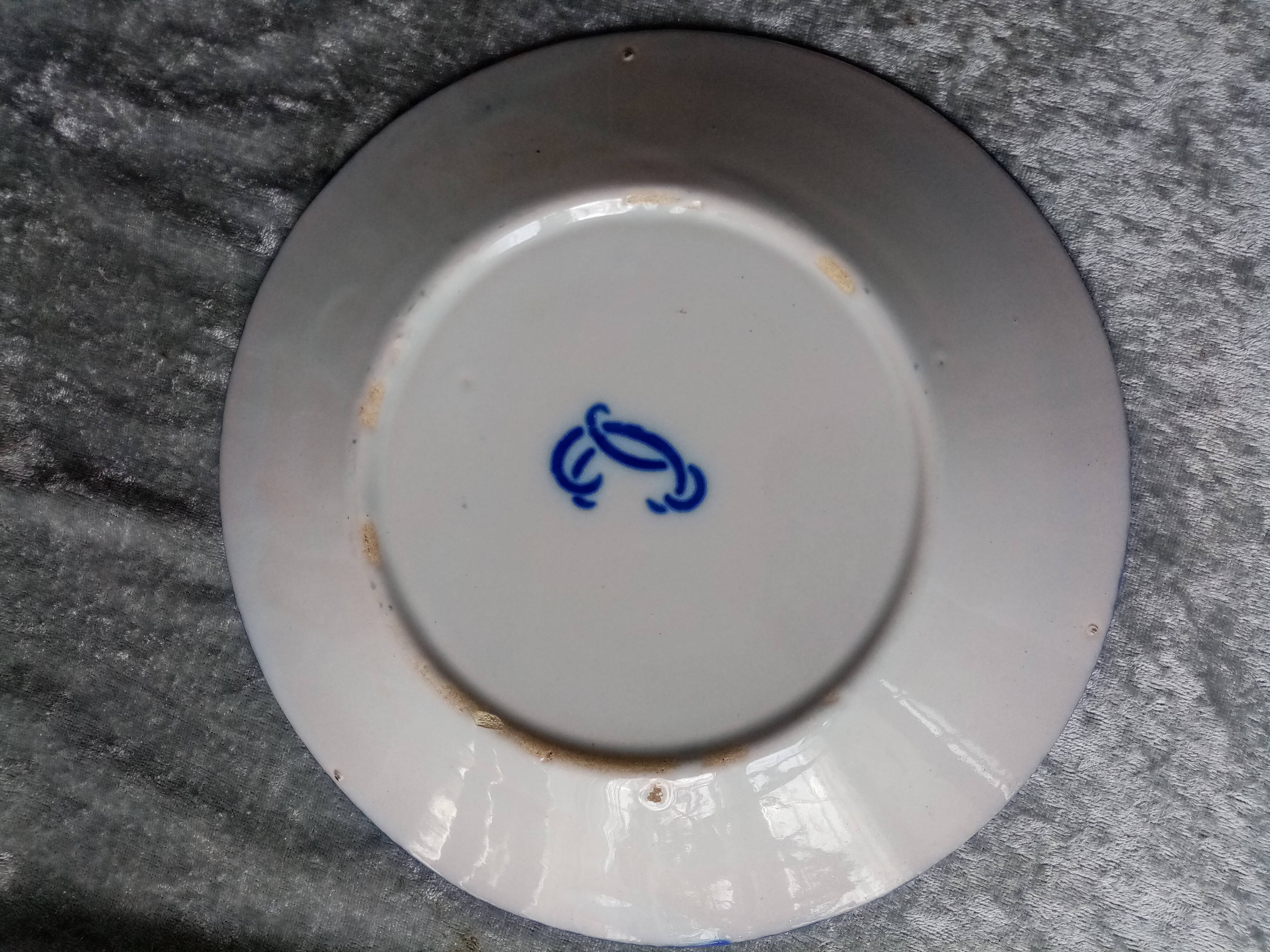 18th century earthenware decorative plate signed Saint Clement with royal coat of arms decoration