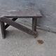 Low stool in vintage brown painted pine from the 1940s, with a rectangular seat.