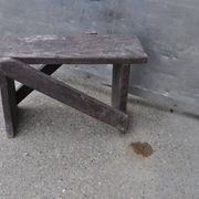 Low stool in vintage brown painted pine from the 1940s, with a rectangular seat.
