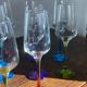 Champagne coupes in glass, multicoloured stems.